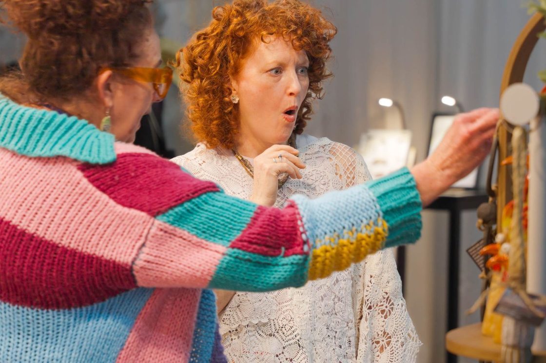 Shoppers browsing at a Signatures handmade market