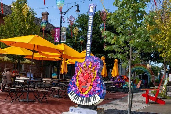 An artist-designed guitar sculpture on a downtown Kingston street